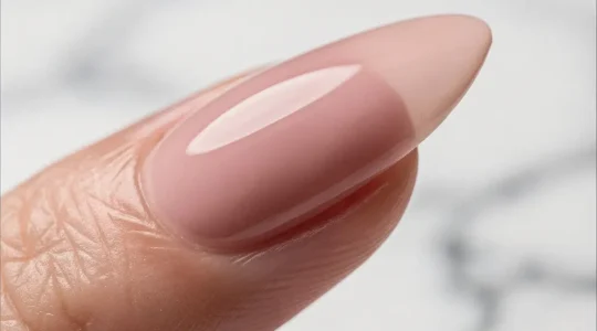 Professional manicure showing the structural apex of long sculpted nails from side profile view