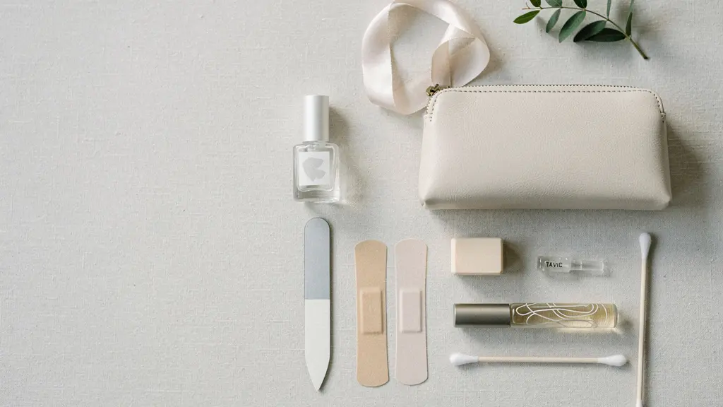 Minimal flat lay of a wedding clutch opened beside a small nail SOS kit with a file and clear top coat, styled with negative space.