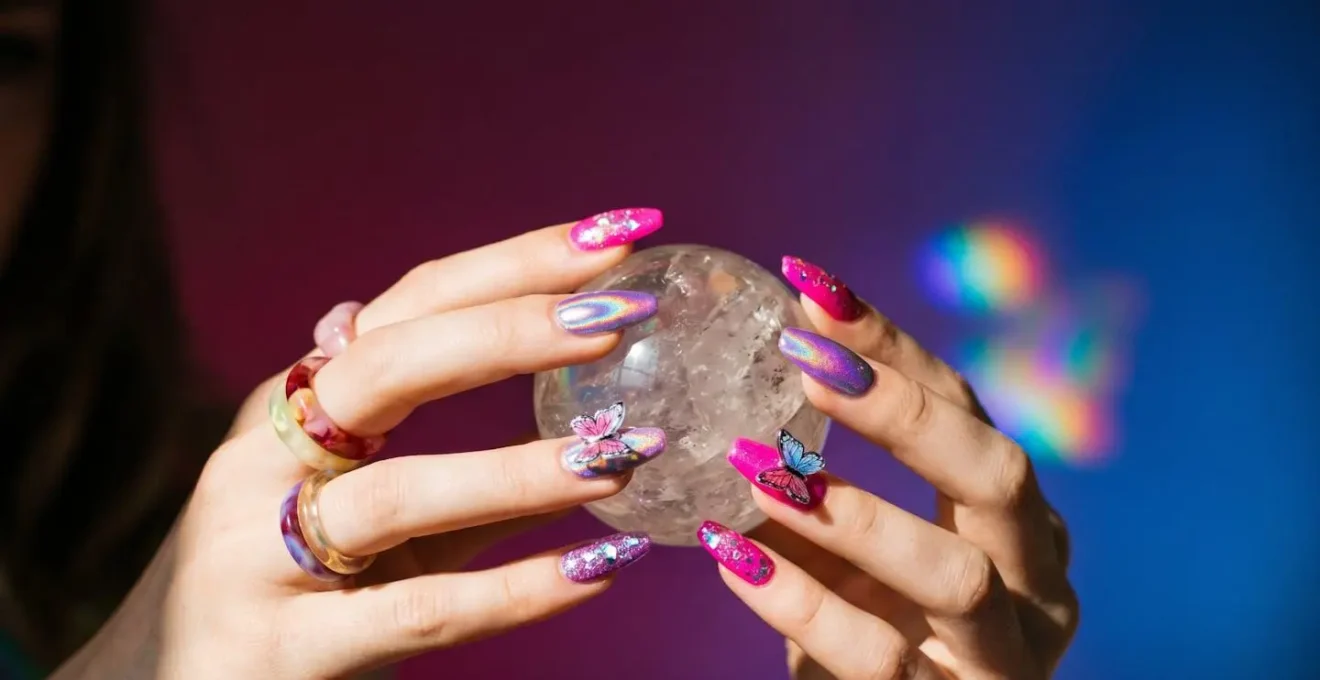 Vibrant Y2K-inspired nail art featuring playful colors and butterfly motifs capturing Gen Z maximalist self-expression aesthetic